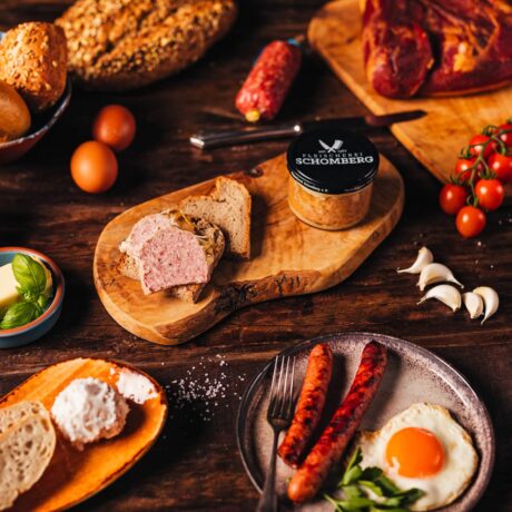 Gehacktes im Glas auf einem Holzbrett und Leckeres gehacktes verstrichen auf einem stück Brot