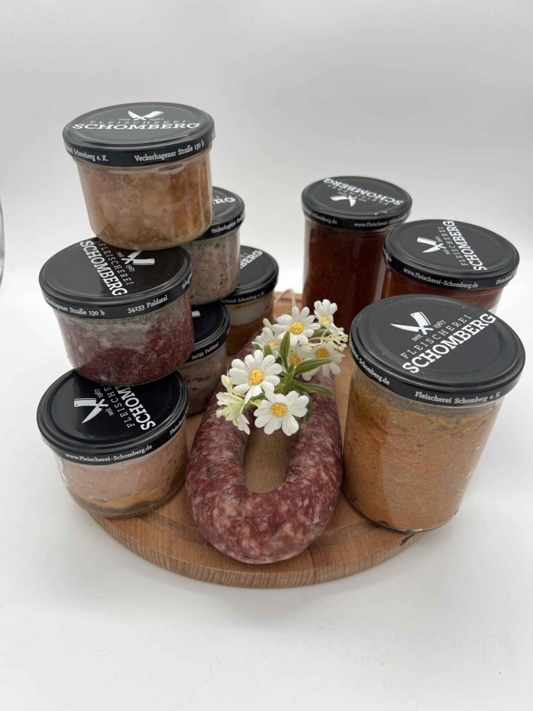 Wurst im Glas z.B Leberwurst im Glas, , gehacktes im Glas und Ahle Wurst Rund – Vorratspaket der Fleischerei Schomberg auf rustikalem Holzbrett angerichtet